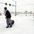 Eric Carter, with Signs and Marking department of Springdale Public Works, places a stop sign at Har...