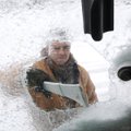 Carlos Barragan with Arko Excavation scrapes ice from the windows of a front end loader before start...