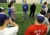Rogers High baseball coach Matt Melson talks to his players before the start of their practice Wednesday.
