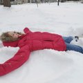 Emily Soden, 8, makes a snow angel Saturday, Jan. 30 at her home in Rogers.