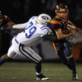 Rogers Heritage running back Zac Stewart, right, runs around Rogers High defensive lineman Britton C...