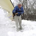 SNOW JOB - Howard Hoogshagen, 84, shovels snow from his driveway Saturday outside his home along Lan...