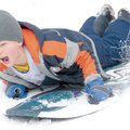 Caleb Garner, 7, of Fayetteville yells while sledding down a hill Saturday north of Razorback Stadiu...