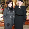 Hostess Barbara Phillips, left, helps Carolyn Schwyhart celebrate her birthday Tuesday.
