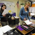 Caity Church, left, and Ruth Hollinger work with their sixth grade English students Alondra Mendez, ...