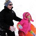 Lindsay Hennarichs and her daughter Victoria, 4, laugh after falling off their sled Saturday at J.B....