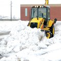 A LOT OF WORK - School district employee Todd Longnecker clears the parking lots of Bentonville High...