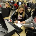 PARENTAL GUIDANCE - Sherry Slusher of Bella Vista helps her daughter, Madison, 13, do research for h...