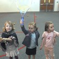 SWINGING INTO ACTION - Ansley Middleton, 4, from left, Hannah Fleming, 4, and Brooke Gruber, 5, hold...