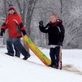 TIME TO SLIDE - Brothers Gaven Long, 11, left, and Dylan Long, 11, carry a sled up a hill outside Li...