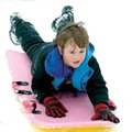 ALL DOWNHILL - Aaron Osterman, 12, of Springdale slides down an embankment Sunday at the Randal Tyso...