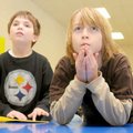 Cameron Prince, 7, and Zach Felt, 9, consider an answer Monday in an Adventure Club quiz at Thomas J...