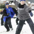 Mason Griffin, 9, right, gets ready to launch a snowball Monday at a friend as his brother, Case Gri...