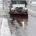 A snow plow clears residual snow Monday from 48th Street in Springdale.