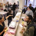 CAMPUS KINDNESS - Law students at the University of Arkansas line up Tuesday to buy bagged lunches a...