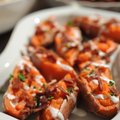 Loaded Sweet Potato Skins, which are twice-baked and topped with a small amount of crumbled bacon an...