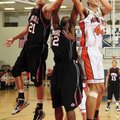 Springdale’s Joseph Kellogg, left, and T.J. Andrews fight for a rebound with Rogers Heritage’s Jon W...