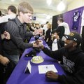 Fayetteville’s Josh Hale, right, is congratulated by Bobby Nefzger, 18, after a signing ceremony at ...