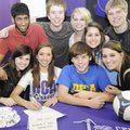 Fayetteville’s Sarah Correll, second from left in front, smiles with friends after signing a letter ...
