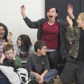 Students at Owl Creek School cheer Wednesday during a charity basketball game between students and f...