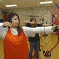  Daisy Velasquez watches an arrow fly after she released it while shooting next to Shelby Downs, rig...