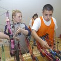 Jackie Grubb, left, and JJ Vallejo select bows to shoot.