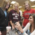  Bentonville’s Rylea Wallace, from left, Abby Risner, and April Miller look at a photo Wednesday tha...