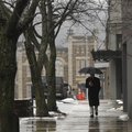 WET WALK - Rick Taylor of Little Rock walks along Mountain Street on Thursday while a light rain fal...