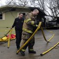 Lt. Devin Reaves, left, and Lt. Robert Hamilton, both of the Bella Vista Fire Department, work to re...