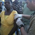 Dr. Lance Faddis gives a shot to a Haitian woman. Faddis was in Haiti with a group from the Rogers F...