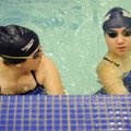  Har-Ber High School swimmers Kelsey Odell, left, 15 and Hannah Lee, 16, practice Thursday before ta...