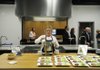 Lisa Clayton, culinary team member with Tyson Foods, serves a bowl of tomato basil soup Friday during a sampling of new foods introduced by Tyson Foods at the shareholders meeting in Springdale.
