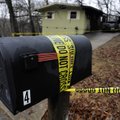 Police tape still wraps the scene Friday where a family of five died when a fire swept through their...