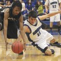 Bentonville’s Mytaah Crawford, left, and Rogers’ Wyatt Hively dive for a loose ball Feb. 5 as the Mo...