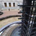 UNIQUE PERSPECTIVE - A pedestrian passes Friday between Vol Walker Hall that houses the University o...
