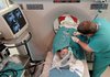 Dr. David Hays places needlelike probes into Yvonne Moore’s liver during surgery in January at Baptist Health Medical Center in Little Rock.