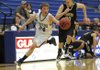 Rogers High’s Keifer Holt takes control of a loose ball during Thursday’s game against Bentonville Black in Rogers.
