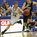Rogers High’s Keifer Holt takes control of a loose ball during Thursday’s game against Bentonville B...