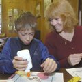 HEART’S IN THEIR WORK - Connor McClure and his mom, Kira McClure, make Valentine cards Saturday at t...