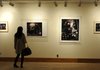 DOWNTOWN DISPLAYS - A visitor checks out photographs Thursday from Kat Wilson’s “Habitats” collection on display in the Fayetteville Underground on the Fayetteville downtown square.