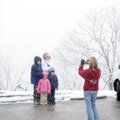 Danyelle Harris of Fayetteville, right, takes a photograph of her family, Caleb, 10, Baylee, 4, Alys...