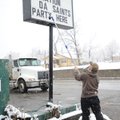 Laddy Diebold, owner of Friendly Liquor on North College Avenue, assembles a sign Monday in Fayettev...
