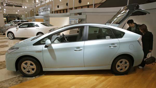 in-this-feb-6-2010-photo-a-couple-check-the-hatchback-of-a-toyota-motor-corps-new-prius-hybrid-at-the-toyota-museum-in-toyota-central-japan