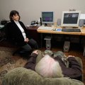 Elise Burt, a neurofeedback and biofeedback counselor in Fayetteville, works with a client Monday.