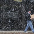 A pedestrian walks along a snowy Emma Ave in Springdale Monday. The National Weather Service is call...