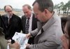  
Jacksonville mayor Gary Fletcher, left, and city staff members Jim Durham, Jay Whisker and Kristen Griggs talk about construction plans on the site where a new farmer's market will be built next to the city hall and community center complex in Jacksonville.
