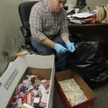 Springdale Police Capt. Ron Hritz unpacks medication Monday while disposing of more than 150 pounds ...