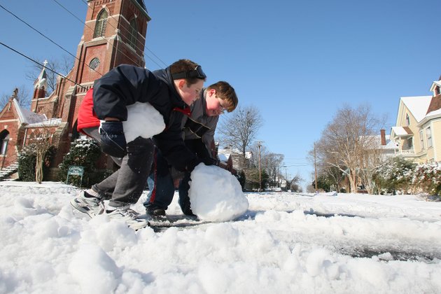julian-francoeur-left-and-alex-perry-both-11-roll-a-large-snowball-down-center-st-across-w-15-st-in-little-rock-tuesday