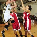 Bentonville’s Montana Lewis shoots over Fort Smith Northside’s Manasha Bell, center, and Kindra Dare...
