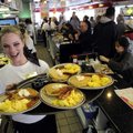 SERVICE WITH A SMILE - Richelle Merrifield carries a tray of free breakfasts to one of her tables Tu...